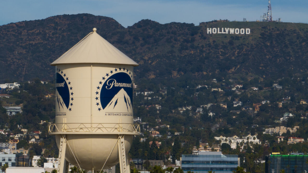 Paramount-branded water tower with the Hollywood sign on a hillside in the background