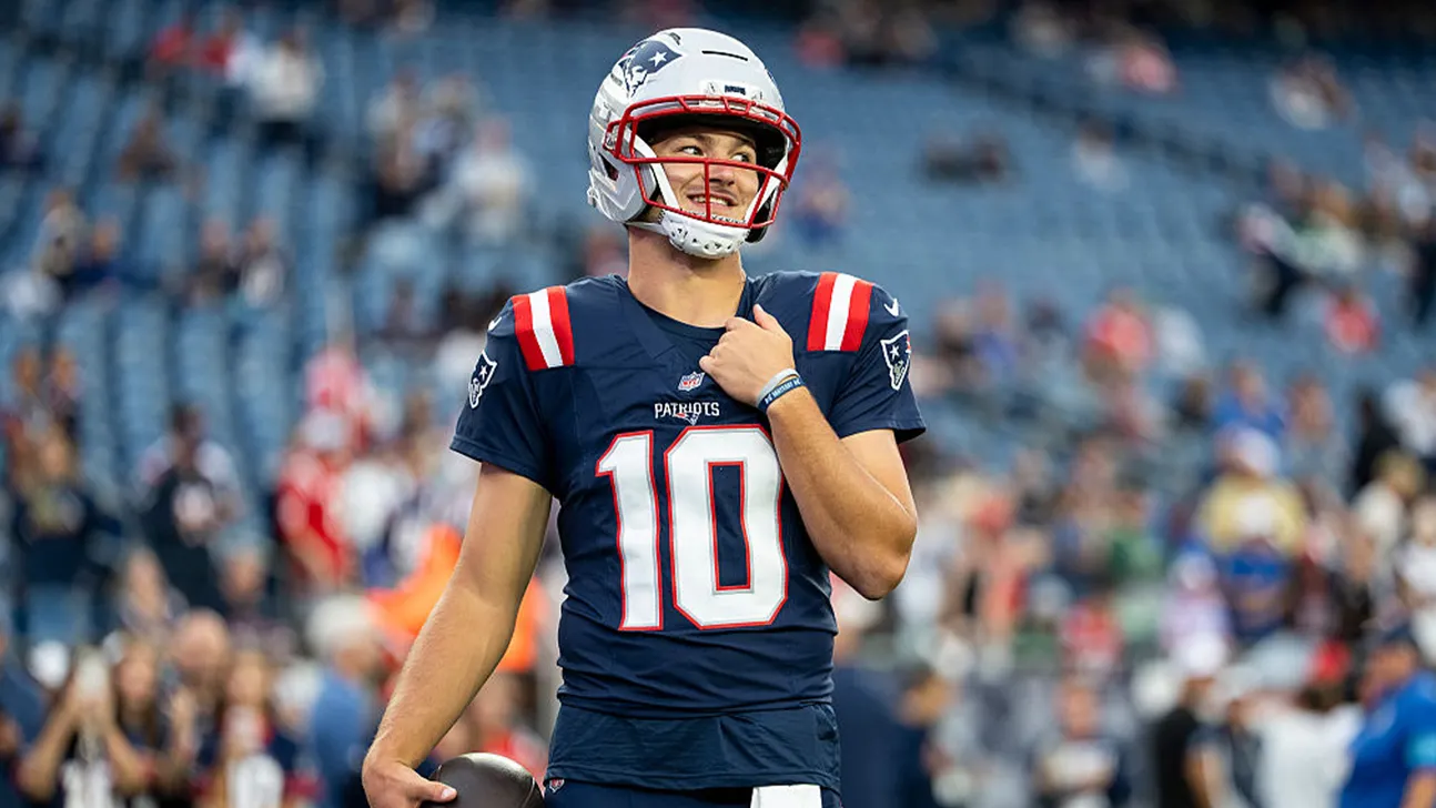 Patriots football player wearing number 10 jersey and helmet during a game