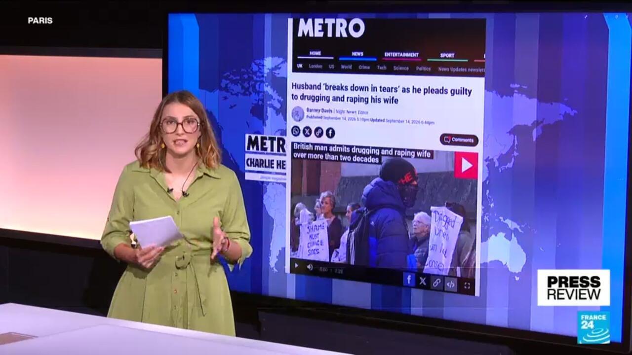 News presenter stands beside a screen displaying a Metro article about a rape case.