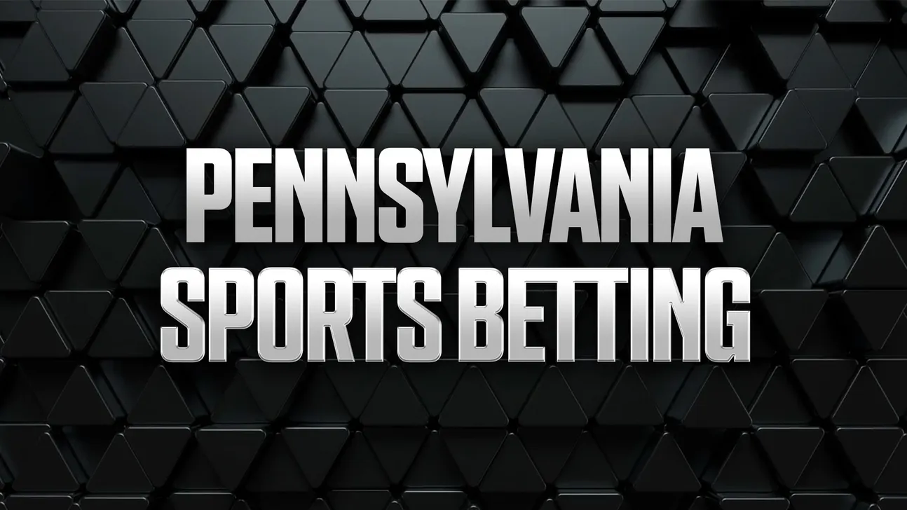 White metallic text reading “Pennsylvania Sports Betting” over a dark geometric triangular pattern.