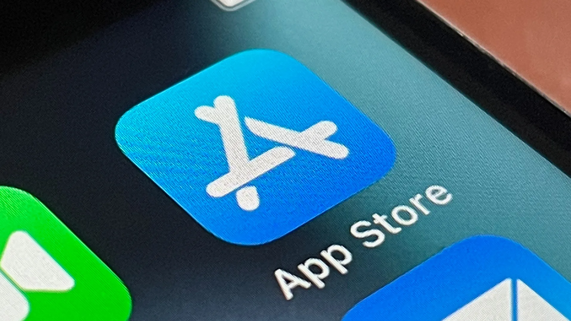 Close-up of an iPhone screen displaying the blue App Store icon and label.