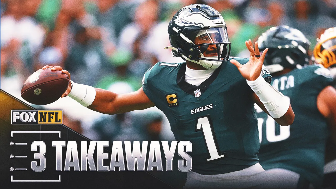 Philadelphia quarterback in green uniform throws football during game as crowd blurs behind him