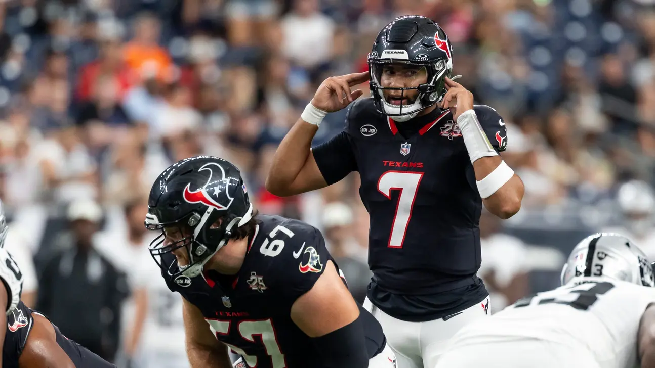 Houston Texans quarterback signals at the line during an NFL game against the Raiders