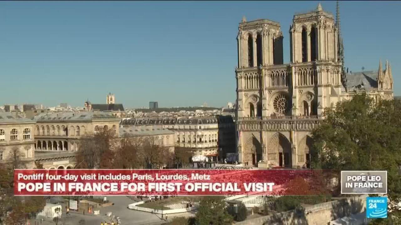 Notre-Dame Cathedral’s twin towers rise above Paris rooftops beneath a clear blue sky, with a French news banner below.