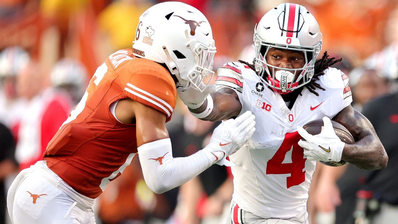 Ohio State ball carrier runs past a Texas defender during a football game.