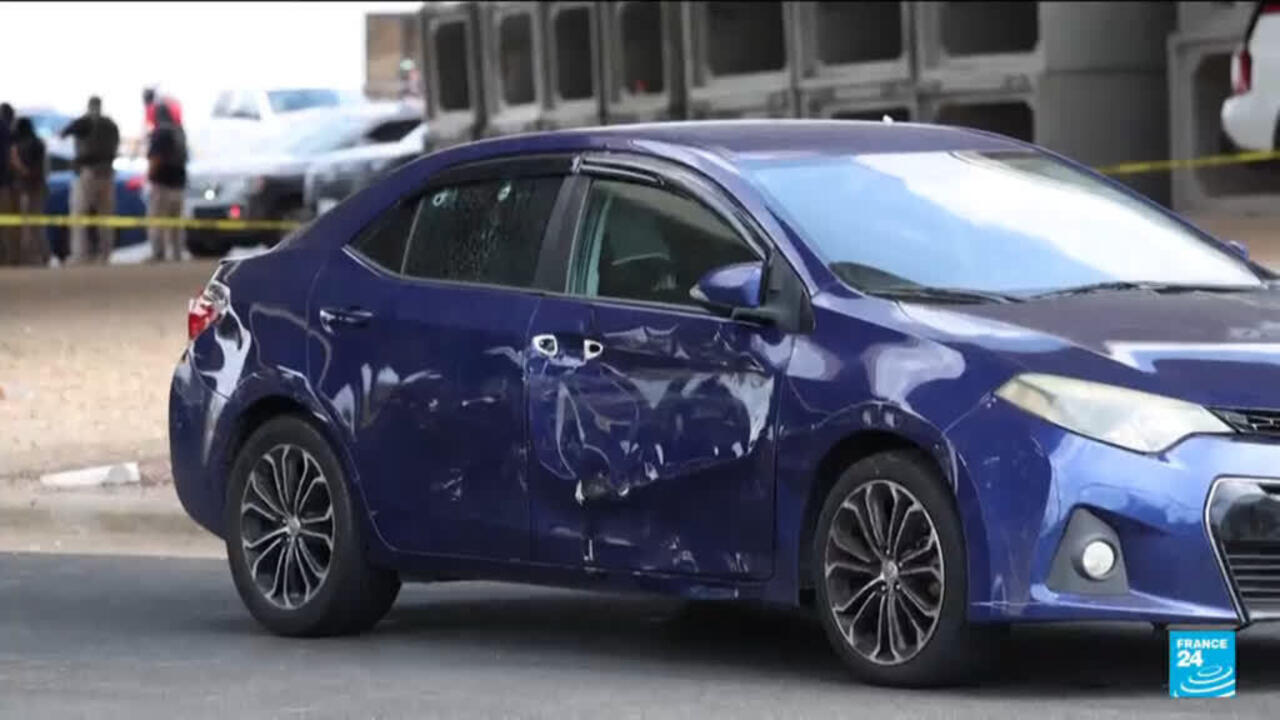 Blue sedan with severe side damage parked near police vehicles and yellow caution tape