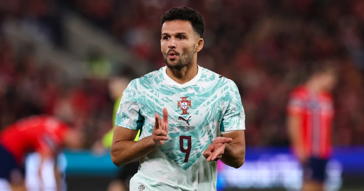 Portugal player in a white and teal number 9 shirt gestures during a match.