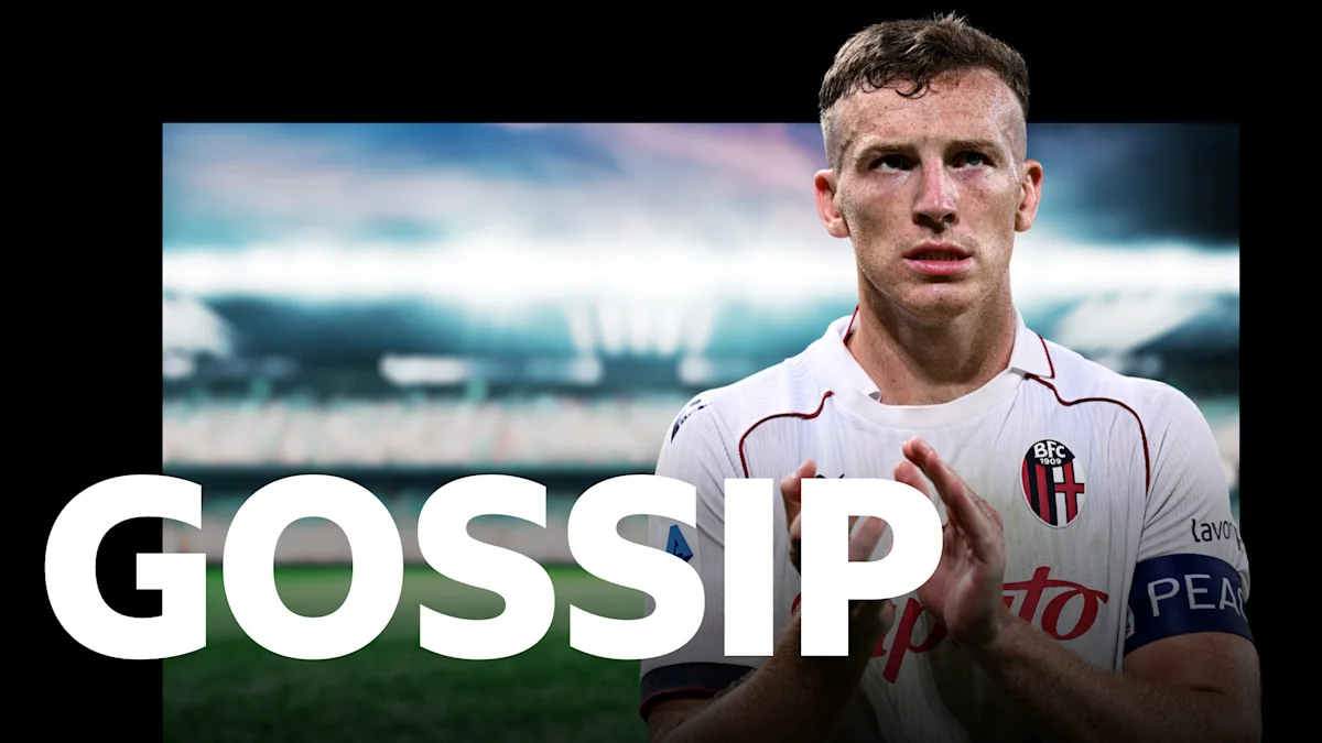 Footballer in white Bologna jersey standing on pitch with large white GOSSIP text overlay