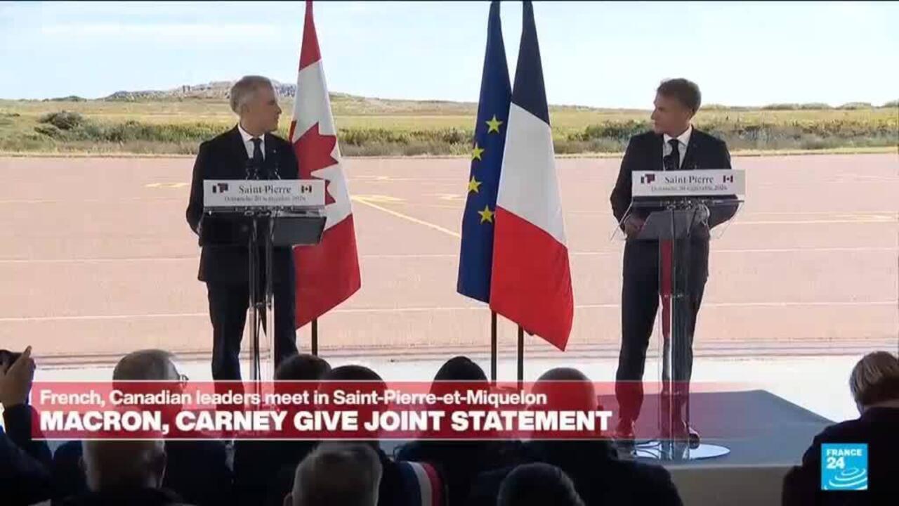 Two officials speak at podiums with Canadian, French, and European Union flags behind them.