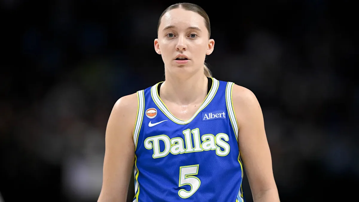 Basketball player in blue Dallas jersey number 5 standing on court