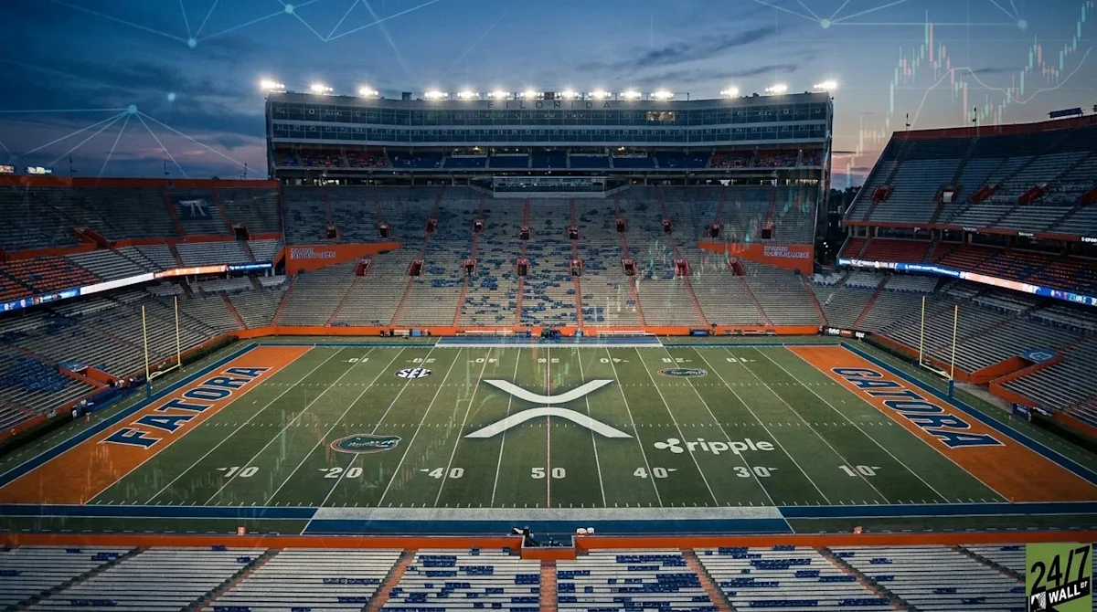 Empty college football stadium with Ripple XRP logo displayed at midfield and price-chart graphics overhead