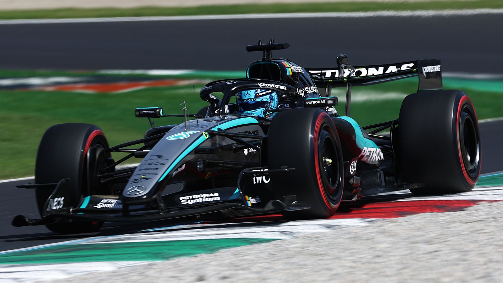 Mercedes Formula One car speeding through a corner on a racetrack