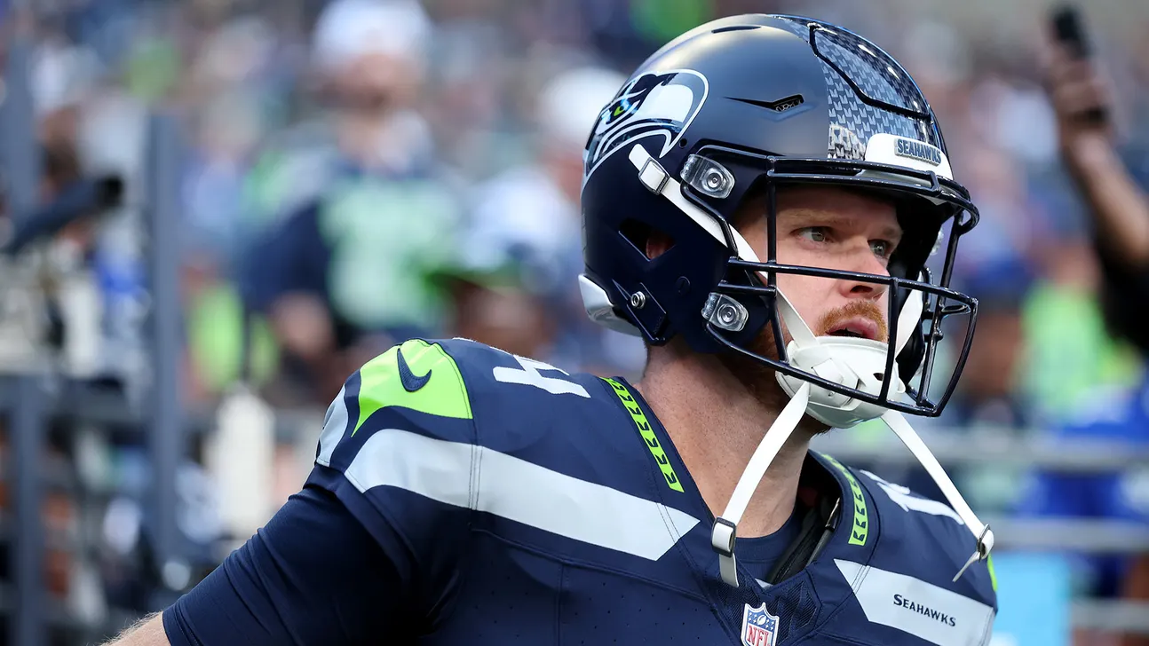 Seattle Seahawks quarterback wearing a helmet and uniform on the football field