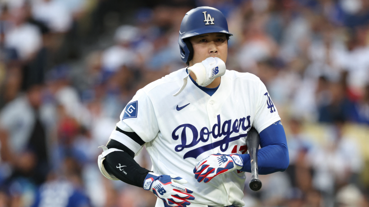 Los Angeles Dodgers player Shohei Ohtani runs wearing a helmet and batting gloves.