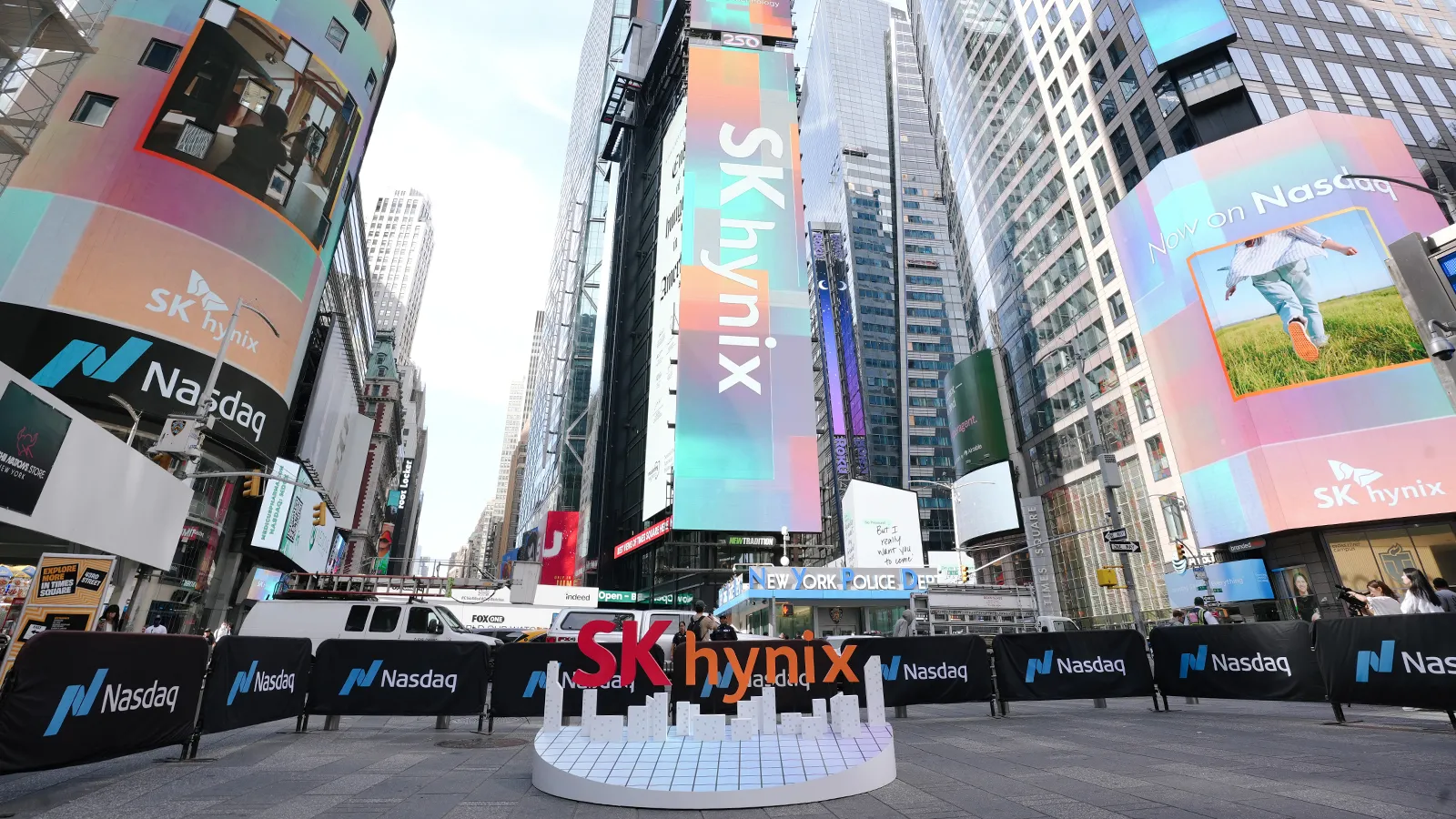SK hynix advertisements and branded installation displayed among skyscrapers in a busy commercial plaza