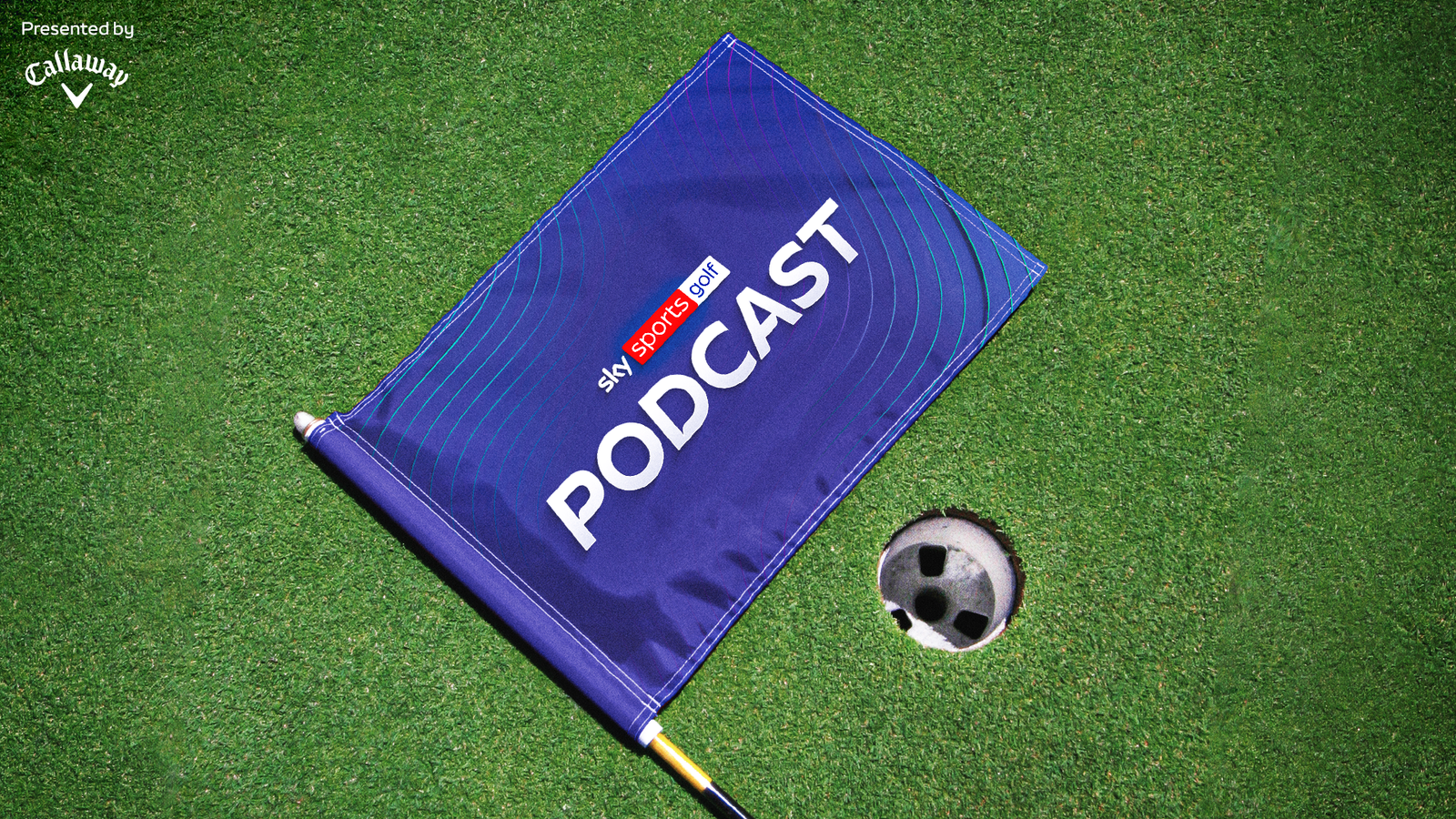 Blue golf flag bearing Sky Sports Golf Podcast branding beside a golf ball on artificial turf.