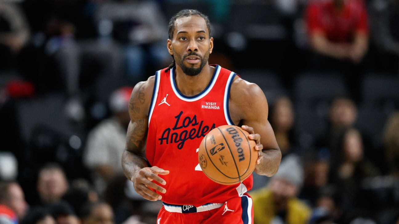 Basketball player in a red Los Angeles Clippers uniform holding a basketball during a game