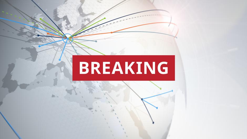 Breaking news graphic featuring a red banner over a world map with colorful connecting lines.