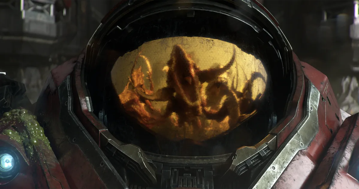 Close-up of a red armored helmet with an indistinct creature reflected in its golden visor.