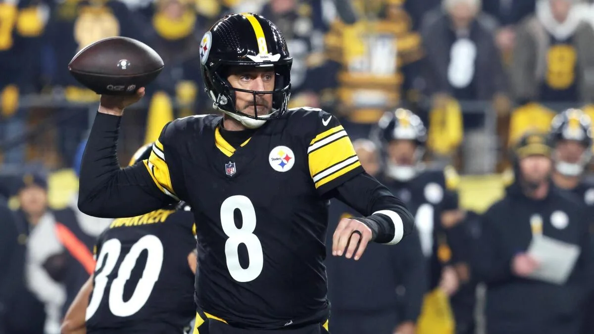 Pittsburgh quarterback in black uniform prepares to throw during a football game