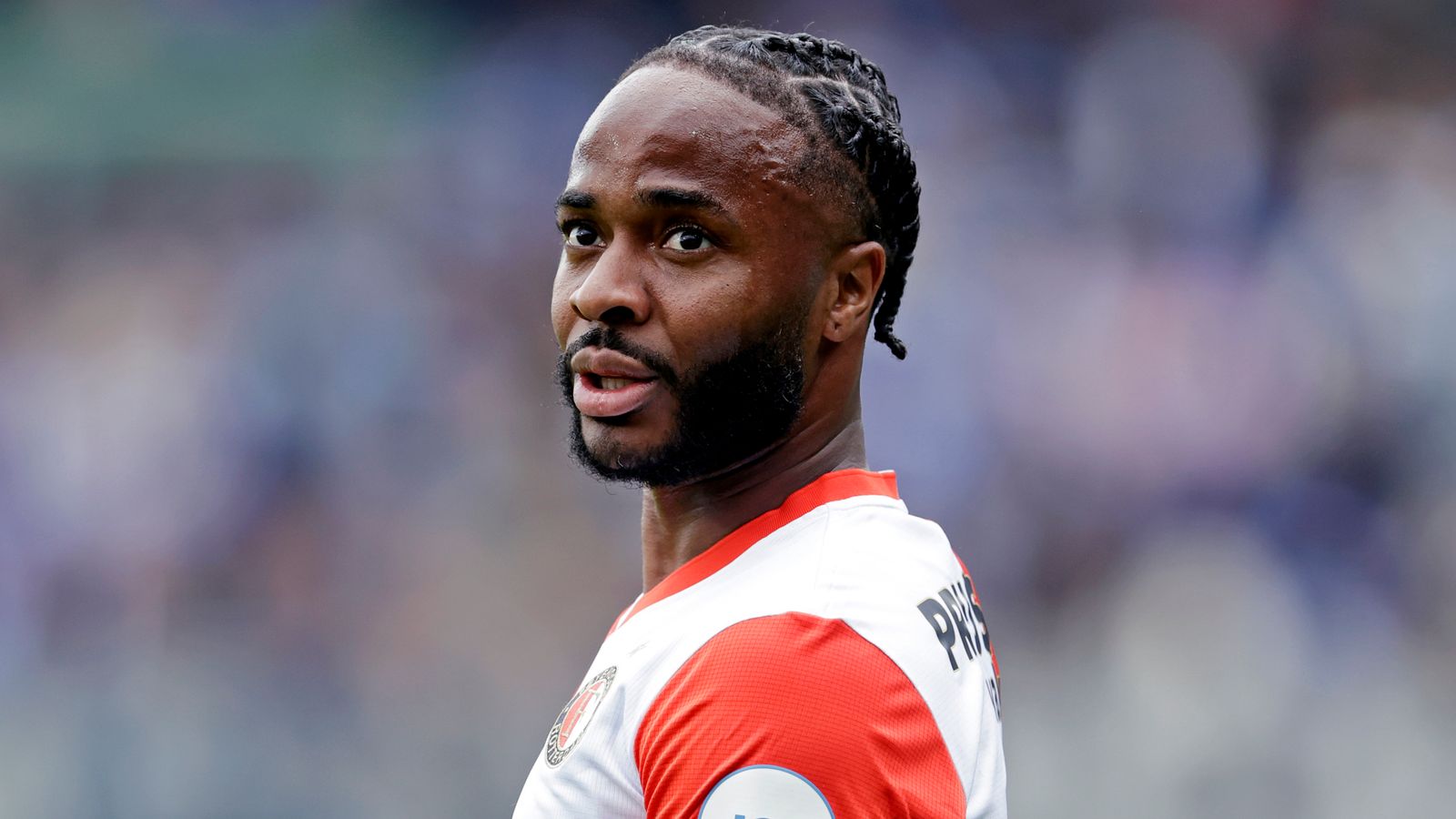 Footballer in Arsenal shirt looking over his shoulder during a match