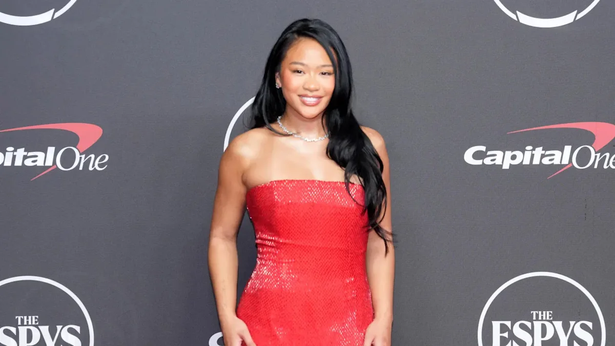 Woman in a red sequined dress poses before a Capital One and ESPYs backdrop