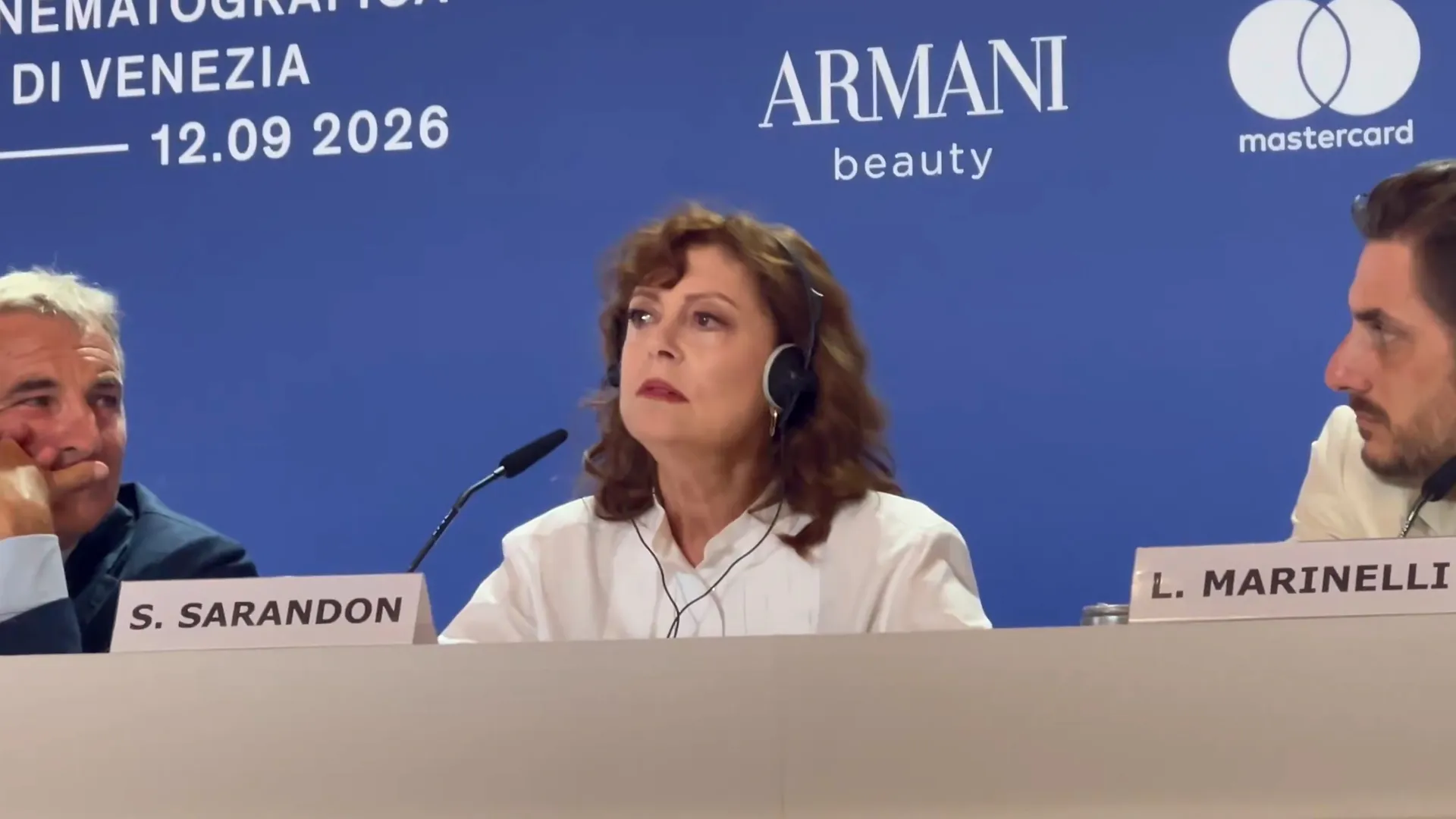 Susan Sarandon sits on a panel between two men at a Venice event.