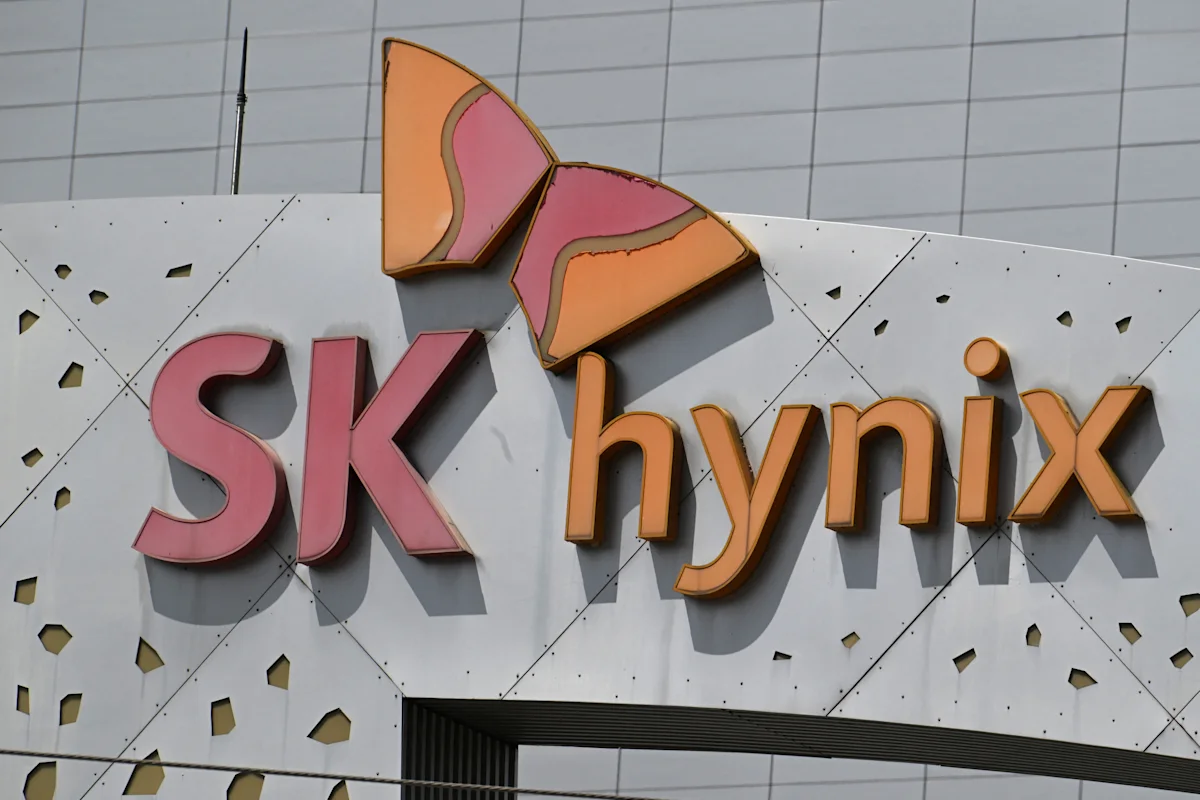 Exterior sign for SK hynix featuring pink and orange lettering with butterfly-shaped logo.