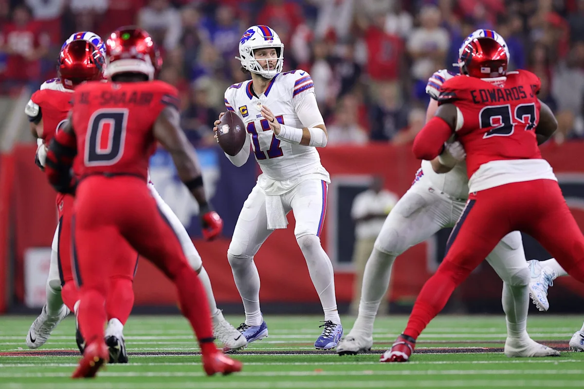 C.J. Stroud prepares to throw as Houston Texans defenders pressure him during an NFL game.