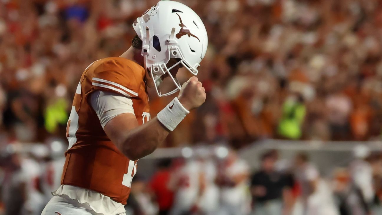 Football player in burnt orange jersey and white helmet pumps his fist during a game.