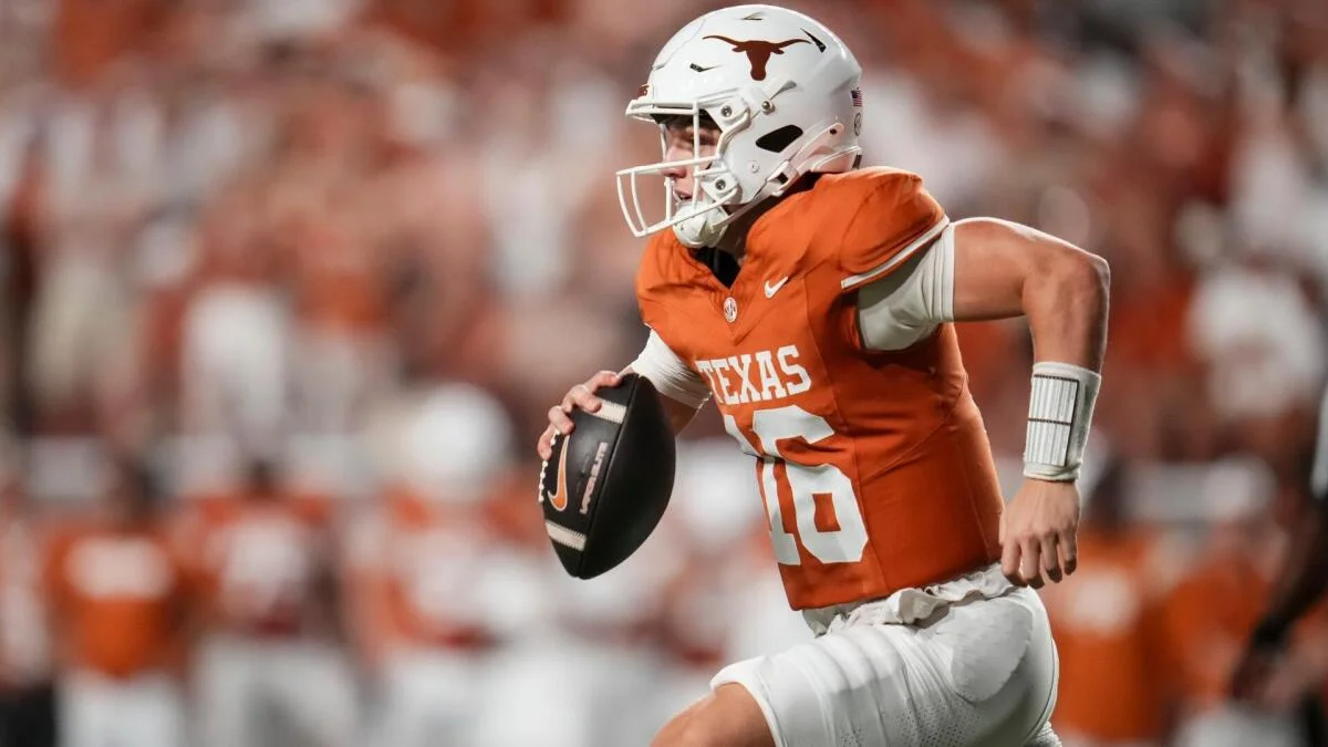 Texas player in an orange number 10 jersey runs with a football during a game.