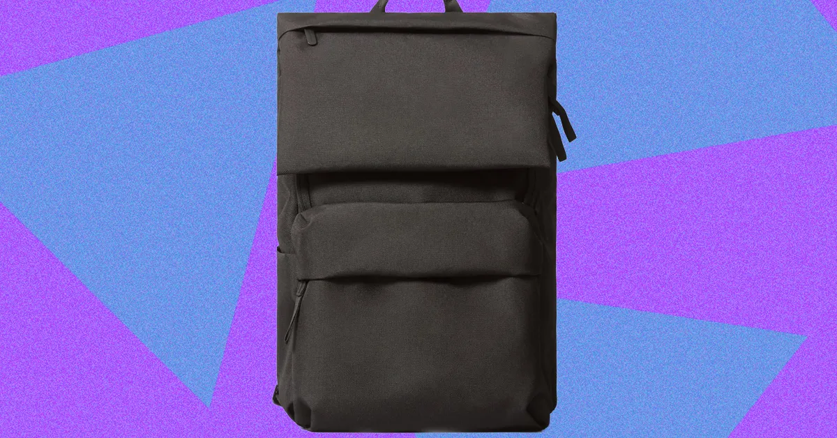 Black backpack displayed against a purple and blue geometric background.