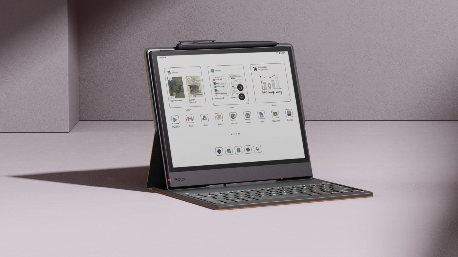 Boox tablet with keyboard and stylus displayed upright on a tabletop against a textured wall