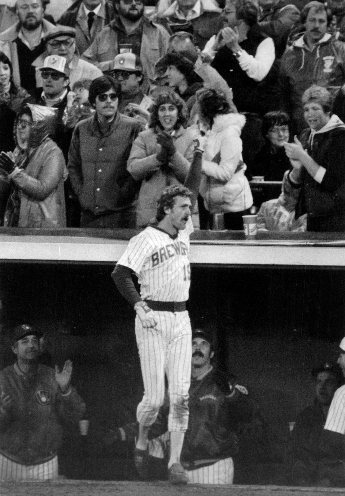 Black-and-white image of Brewers player celebrating as fans cheer behind him
