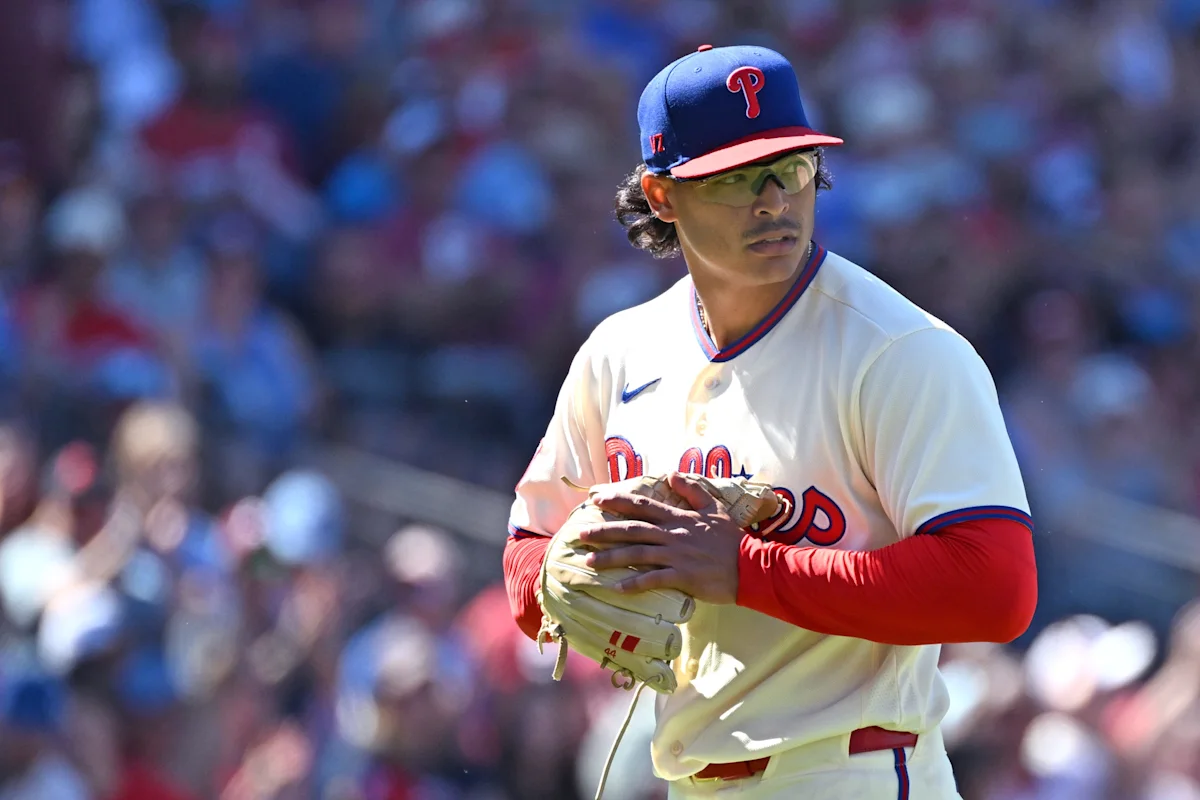 Phillies pitcher in uniform and cap holds a glove during a game