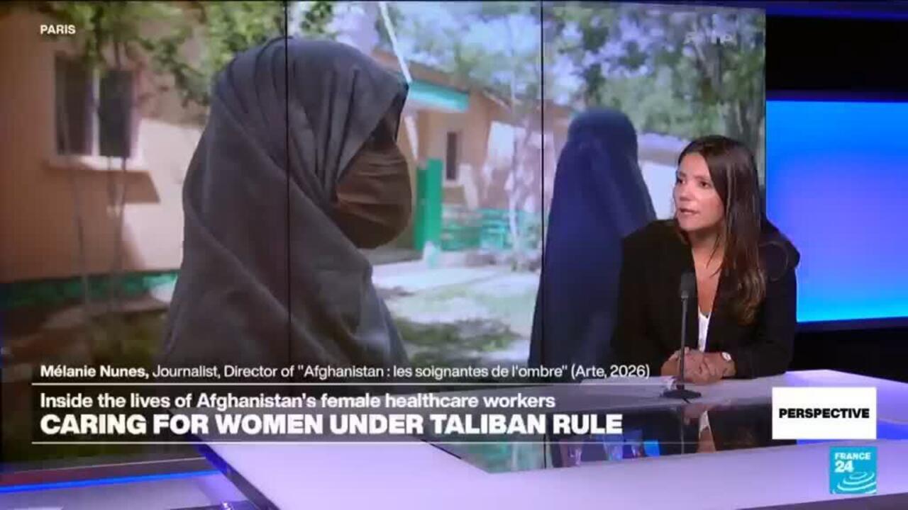 Television interview shows a journalist beside footage of a woman in a full-body veil.