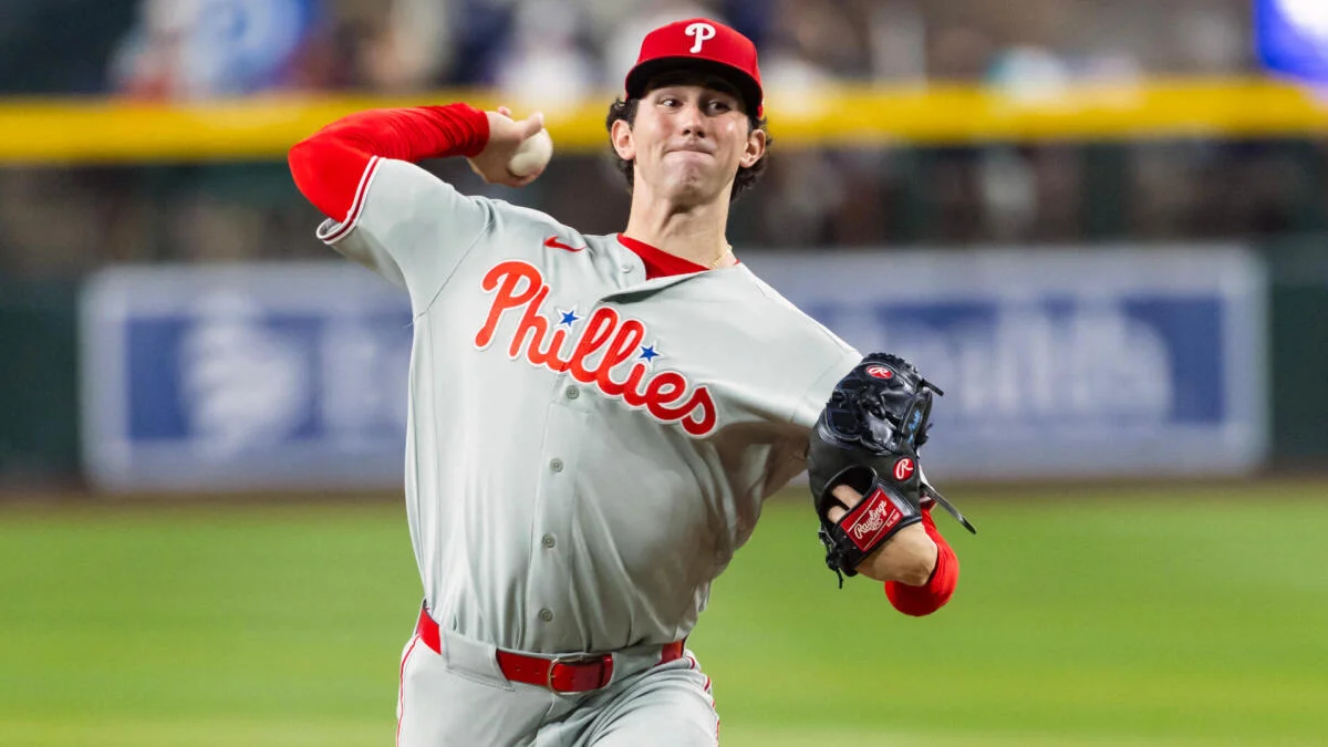 Philadelphia Phillies pitcher in uniform throws a baseball during a game.