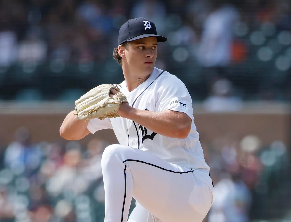 Baseball pitcher in Tigers uniform raises his leg while preparing to throw the ball