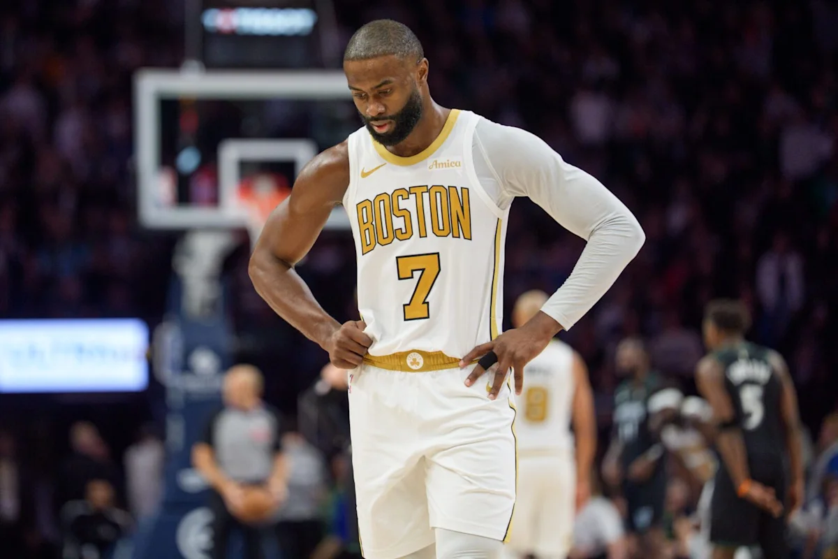 Boston Celtics player in white number seven jersey stands on court with hands on hips.