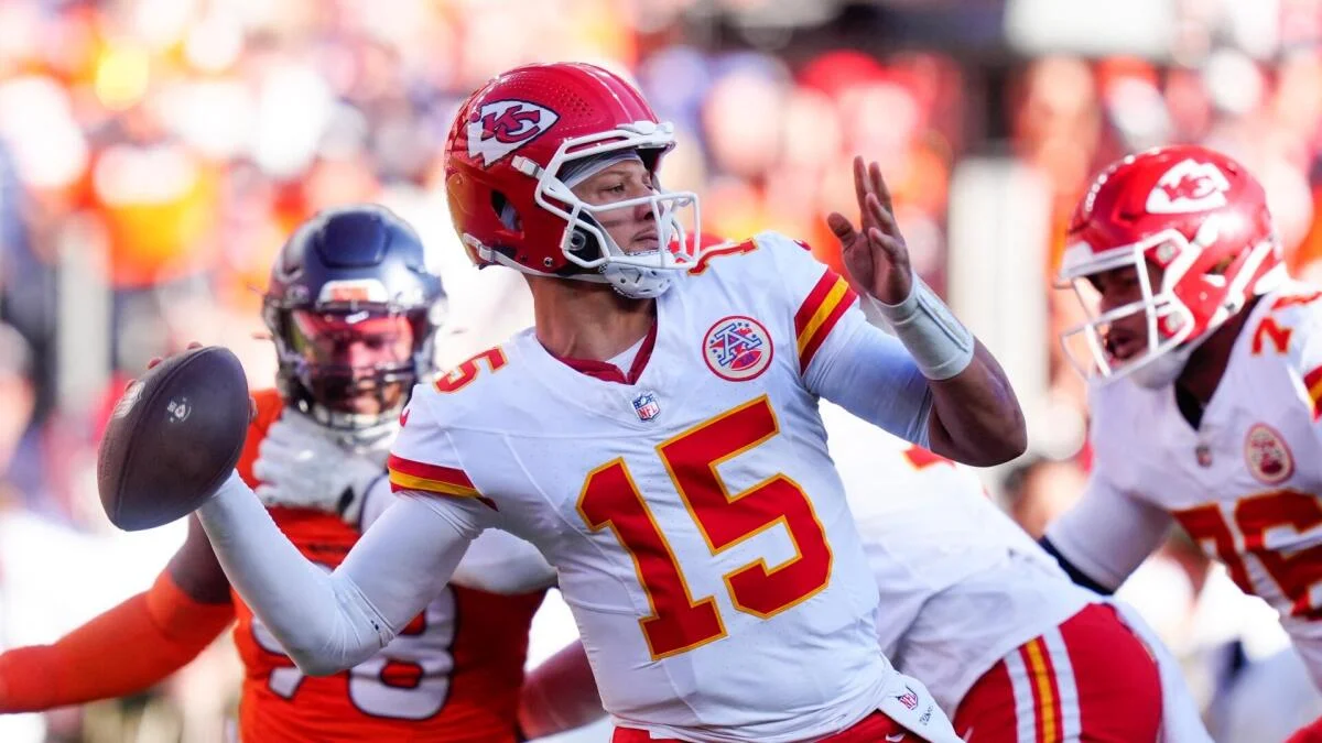 Kansas City quarterback in white uniform throws a football during an NFL game