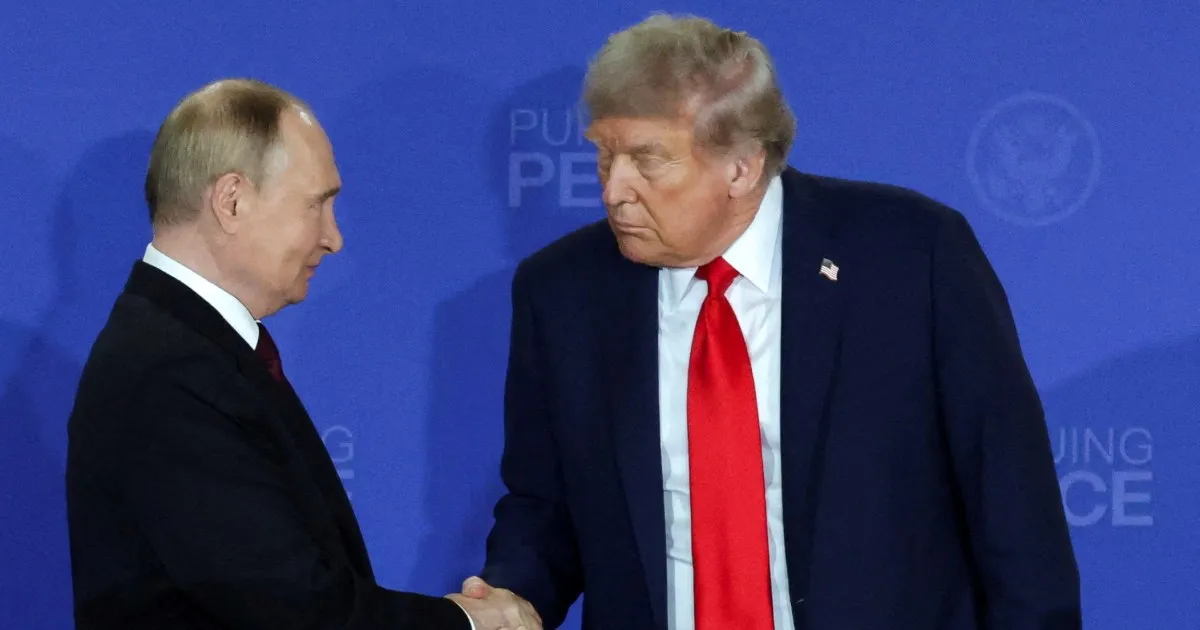 Donald Trump and Vladimir Putin face each other and shake hands against a blue backdrop.