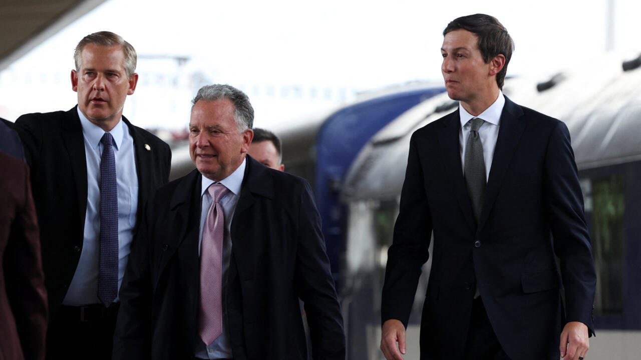 Three suited men walk beside a large aircraft, accompanied by other people.