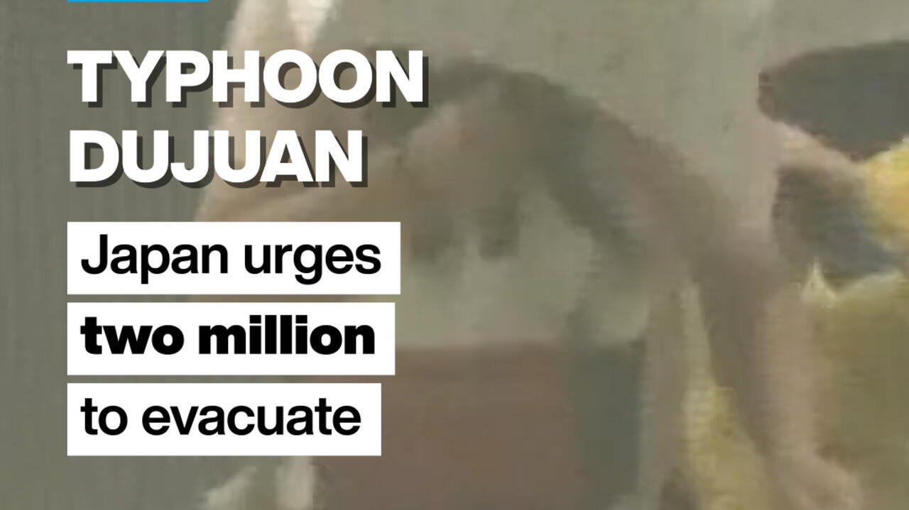 Storm footage behind bold text reading “TYPHOON DUJUAN” and urging two million people to evacuate.
