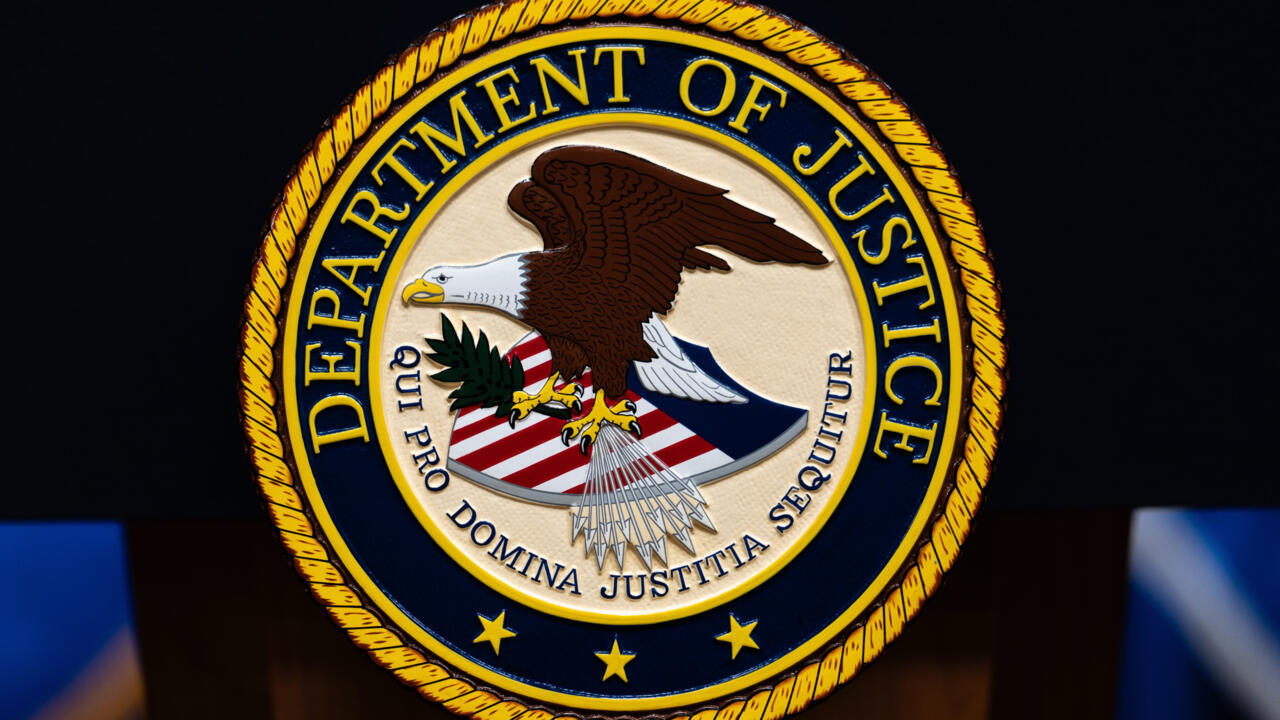 Department of Justice seal featuring an eagle, scales, stars, and the words Department of Justice