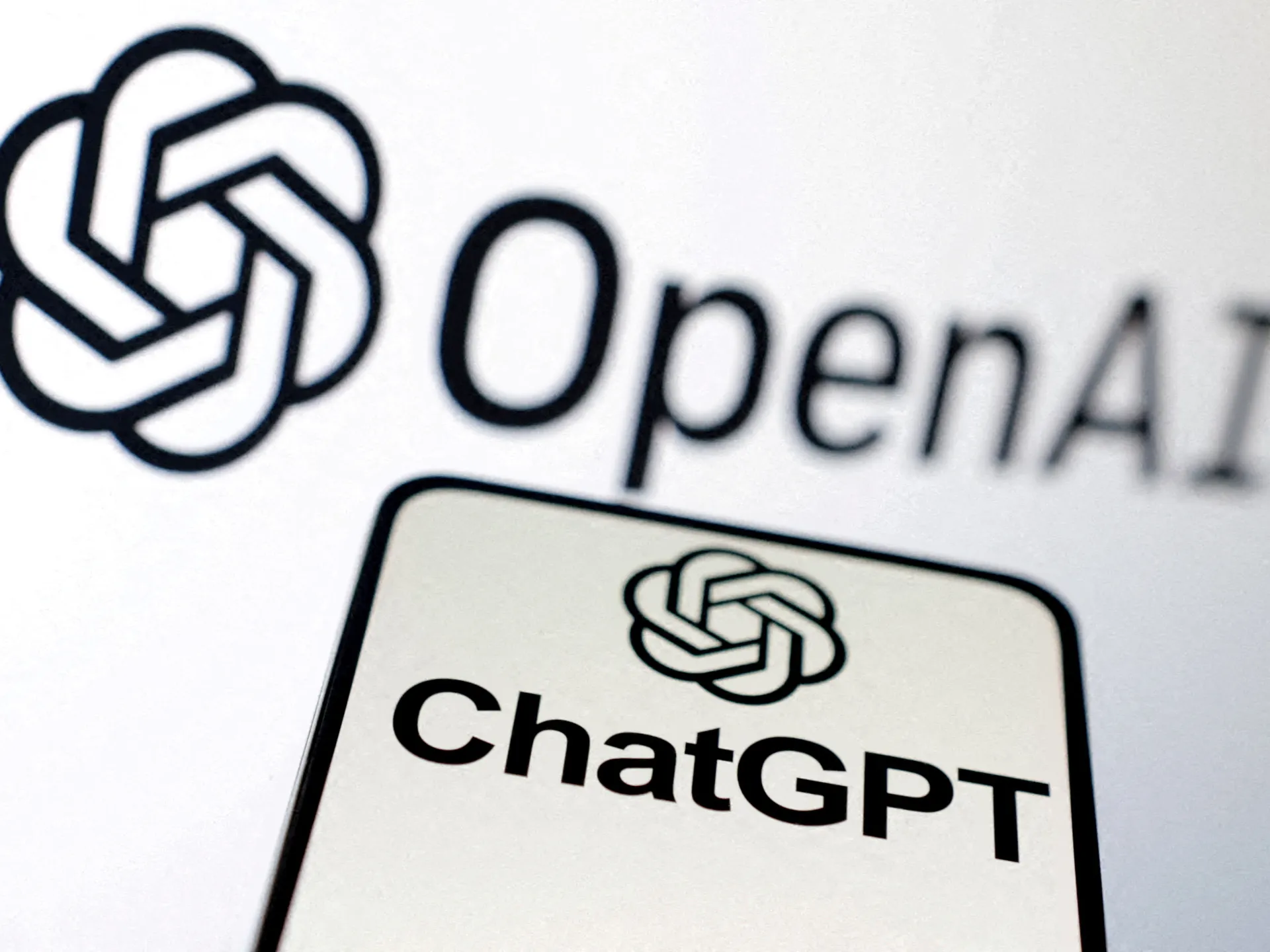 OpenAI logo and ChatGPT label displayed on a tilted device against a white background.
