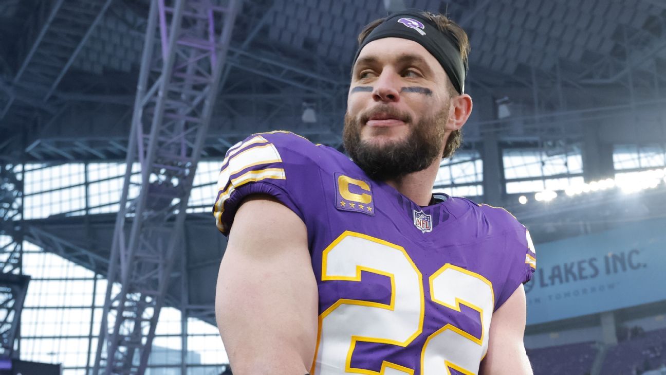 Bearded football player in purple Vikings jersey and black headband standing inside a stadium