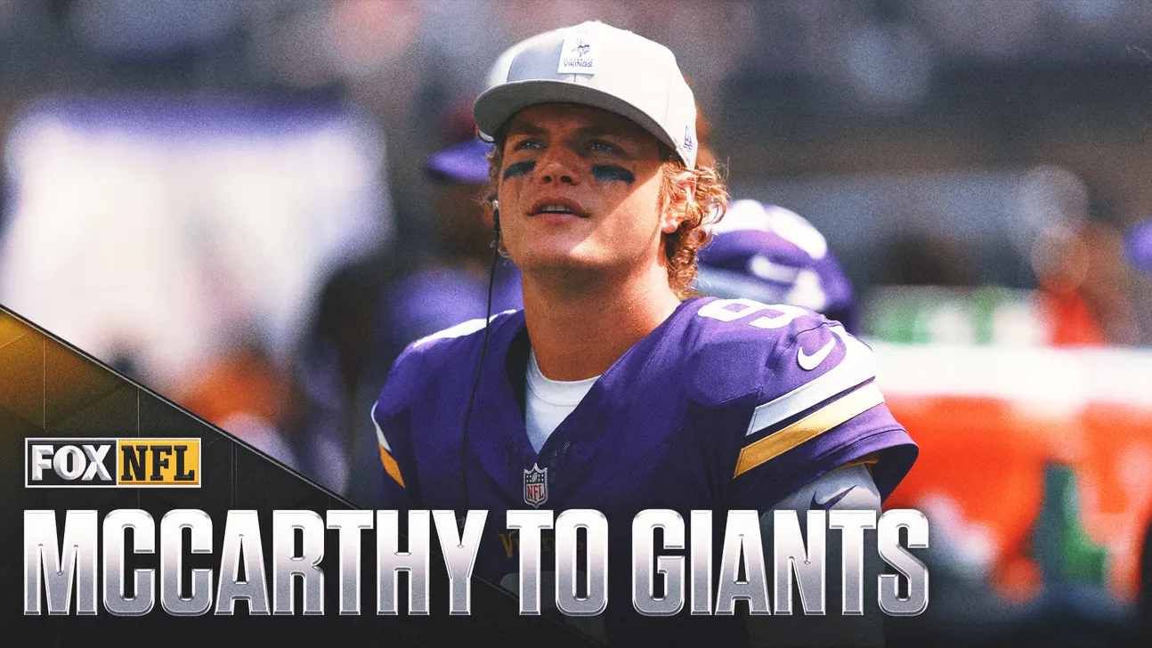 Minnesota Vikings player in purple jersey and white cap stands on the sideline beneath a FOX NFL graphic.