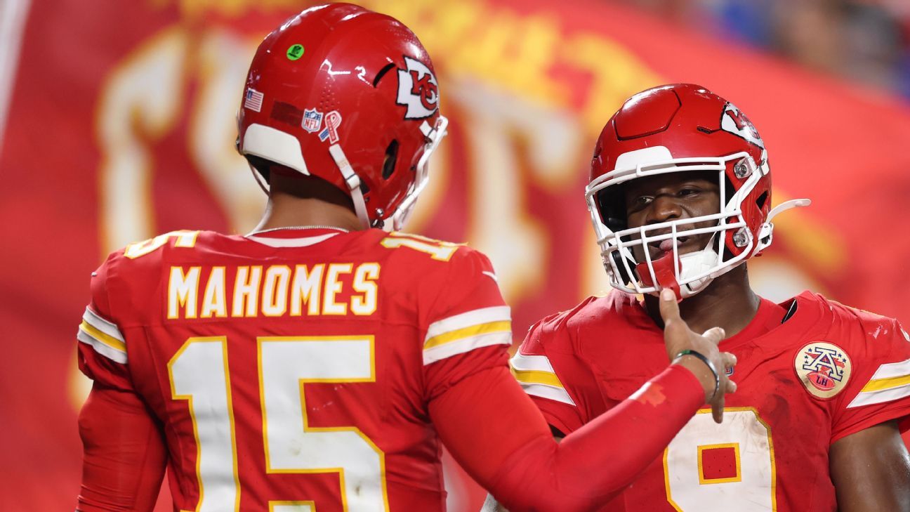 Kansas City Chiefs players Patrick Mahomes and a teammate gesture during a game