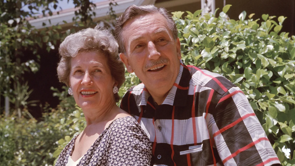 Older couple smiling outdoors, with greenery and a house visible behind them