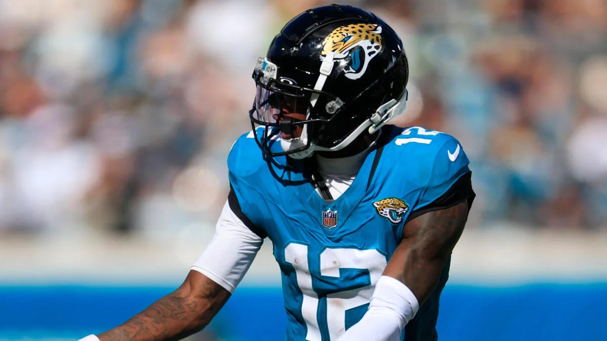 Jacksonville Jaguars football player wearing a black helmet and teal jersey during a game